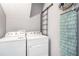 Efficient laundry area with Whirlpool washer/dryer set and convenient wall-mounted ironing board at 6450 Ivey Se Rd, Mableton, GA 30126