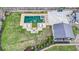 A luxury backyard with manicured lawn, a tranquil pool, lounge area, and covered outdoor pavilion at 2668 Galahad Ne Dr, Atlanta, GA 30345