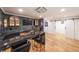 Elegant bar area with dark cabinetry, a mini-fridge, stylish barstools and a hardwood floor at 2668 Galahad Ne Dr, Atlanta, GA 30345