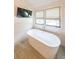 Modern bathroom features a sleek tub, window, and tile walls, providing a relaxing spa-like experience at 2668 Galahad Ne Dr, Atlanta, GA 30345