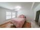 Cozy bedroom with hardwood floors, a bright window with shutters, and a comfortable bed with pink linens at 2668 Galahad Ne Dr, Atlanta, GA 30345