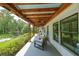 Relaxing covered porch area with ceiling fans, comfortable seating, and views of green foliage at 2668 Galahad Ne Dr, Atlanta, GA 30345