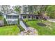Beautiful exterior of home featuring manicured lawn, covered porch with wooden beams and landscaped walkway at 2668 Galahad Ne Dr, Atlanta, GA 30345