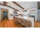 Spacious kitchen featuring large island with seating, stainless steel appliances, and wood floors at 2668 Galahad Ne Dr, Atlanta, GA 30345