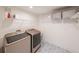 Well-equipped laundry room featuring modern appliances, storage shelves, and a patterned floor for added style at 2668 Galahad Ne Dr, Atlanta, GA 30345