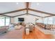 Bright and airy living room featuring beamed ceilings, hardwood floors, and ample seating at 2668 Galahad Ne Dr, Atlanta, GA 30345