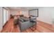 Spacious living room featuring hardwood floors, a sectional sofa, and a large screen for entertainment at 2668 Galahad Ne Dr, Atlanta, GA 30345