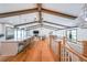 Open floor plan featuring hardwood floors, wood beams, and large windows that provide natural light at 2668 Galahad Ne Dr, Atlanta, GA 30345