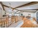 Open-concept living area with hardwood floors, exposed beams, designer lighting, and kitchen views at 2668 Galahad Ne Dr, Atlanta, GA 30345