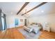 Main bedroom featuring hardwood floors, wood beams, and neutral decor at 2668 Galahad Ne Dr, Atlanta, GA 30345