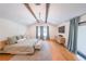 Modern main bedroom with hardwood floors, wood beams, and plenty of natural light at 2668 Galahad Ne Dr, Atlanta, GA 30345