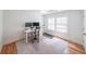 Bright office space with hardwood floors, a large window, a modern desk setup, and a treadmill at 2668 Galahad Ne Dr, Atlanta, GA 30345