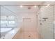 Walk-in shower with white subway tile, glass door, and overhead shower head at 2668 Galahad Ne Dr, Atlanta, GA 30345