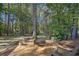The mature trees and landscaping surrounding the backyard deck is perfect for relaxation and outdoor activities at 45 Park Place Dr, Covington, GA 30016