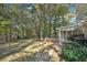 The backyard has beautiful, mature trees and landscaping with a screened in porch and deck attached to the home at 45 Park Place Dr, Covington, GA 30016