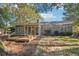 Backyard view with deck featuring potted plants, chairs, and an attached screened in porch at 45 Park Place Dr, Covington, GA 30016