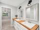 Bright bathroom featuring a double vanity, modern fixtures, and tile flooring at 45 Park Place Dr, Covington, GA 30016