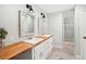 Bright bathroom featuring a double vanity, modern fixtures, and tile flooring at 45 Park Place Dr, Covington, GA 30016