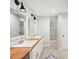 Bright bathroom featuring a double vanity, modern fixtures, and tile flooring at 45 Park Place Dr, Covington, GA 30016