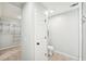 Bathroom featuring a walk-in closet, toilet, and a tiled shower at 45 Park Place Dr, Covington, GA 30016