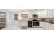 Bright kitchen featuring stainless steel appliances and white cabinetry at 45 Park Place Dr, Covington, GA 30016