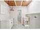Bright laundry room boasts patterned floors, utility sink, and hanging rack with wood ceiling accents at 45 Park Place Dr, Covington, GA 30016