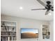 Living room features built-in bookshelves, cabinets, and a ceiling fan at 45 Park Place Dr, Covington, GA 30016