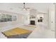 Bright living room with fireplace and vaulted ceiling featuring a fan at 45 Park Place Dr, Covington, GA 30016