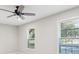 Living room features large windows and a ceiling fan at 45 Park Place Dr, Covington, GA 30016