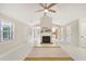 Spacious living room featuring fireplace, white walls, and a fan at 45 Park Place Dr, Covington, GA 30016