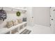 Mud room with a white bench, hooks, storage, and a built in cubbies at 45 Park Place Dr, Covington, GA 30016