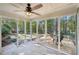 Spacious screened-in patio with a ceiling fan, an outdoor view, and access to the yard at 45 Park Place Dr, Covington, GA 30016