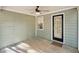 Covered patio with green siding, a ceiling fan, and an exterior door at 45 Park Place Dr, Covington, GA 30016