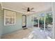 Covered and screened-in patio with green siding, a ceiling fan, and access to the yard at 45 Park Place Dr, Covington, GA 30016