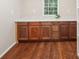 Storage area with beautiful wood flooring and cabinets with white countertops at 45 Park Place Dr, Covington, GA 30016