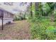 Image shows the backyard of the home, with greenery, leaves, and trees at 5340 The Savoy St, Atlanta, GA 30349