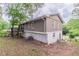 View of the back of the house featuring siding, a deck, and partial basement at 5340 The Savoy St, Atlanta, GA 30349