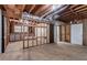 An unfinished basement with exposed ductwork, concrete floor, and framing in need of renovation at 5340 The Savoy St, Atlanta, GA 30349