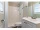 Cozy bathroom featuring tile shower, window, and sink with mirrored vanity at 5340 The Savoy St, Atlanta, GA 30349