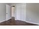Bedroom with hardwood floors, a window, and double closet with an open door at 5340 The Savoy St, Atlanta, GA 30349