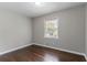 An empty bedroom with hardwood floors and a window letting in natural light at 5340 The Savoy St, Atlanta, GA 30349