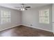 This bedroom features hardwood floors, neutral walls, two windows and a ceiling fan at 5340 The Savoy St, Atlanta, GA 30349