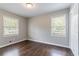 A bedroom featuring two windows and a closet with panel doors, offering ample natural light at 5340 The Savoy St, Atlanta, GA 30349