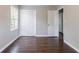 Bedroom featuring hardwood floors, double closet, and a window providing natural light at 5340 The Savoy St, Atlanta, GA 30349