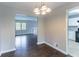 Dining area with view of the living room, kitchen, and dark wood flooring at 5340 The Savoy St, Atlanta, GA 30349