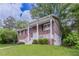 Two-story brick home boasts a covered front porch and well-maintained landscaping at 5340 The Savoy St, Atlanta, GA 30349