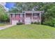 Charming two-story brick home with a well-manicured lawn and welcoming front porch at 5340 The Savoy St, Atlanta, GA 30349