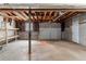 An unfinished basement garage space with a concrete floor, wooden beams, and block walls at 5340 The Savoy St, Atlanta, GA 30349