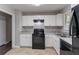 Modern kitchen with white cabinets, a speckled countertop, and stainless steel appliances at 5340 The Savoy St, Atlanta, GA 30349