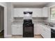Bright kitchen featuring white cabinets, new countertops, and updated black appliances at 5340 The Savoy St, Atlanta, GA 30349